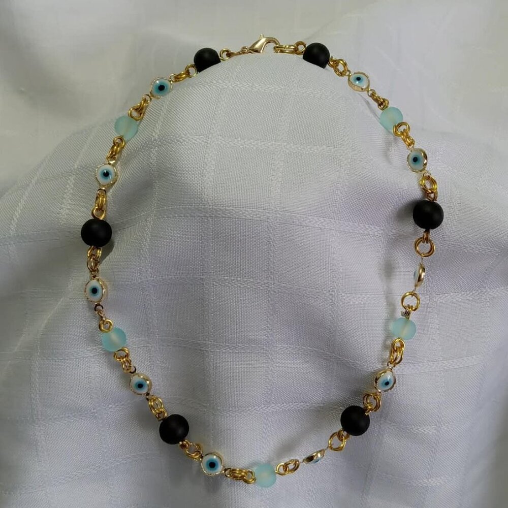 Handmade gold tone necklace with polished stones and evil eyes